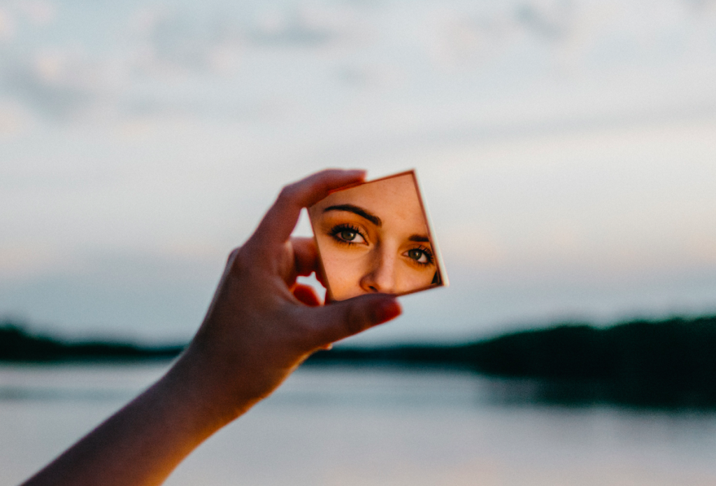 woman looking in mirror