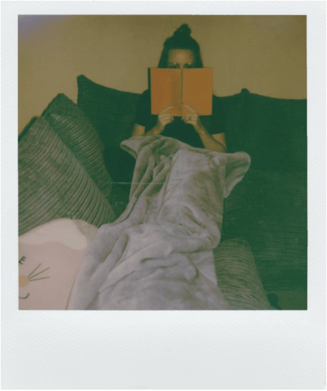 woman reading book at home
